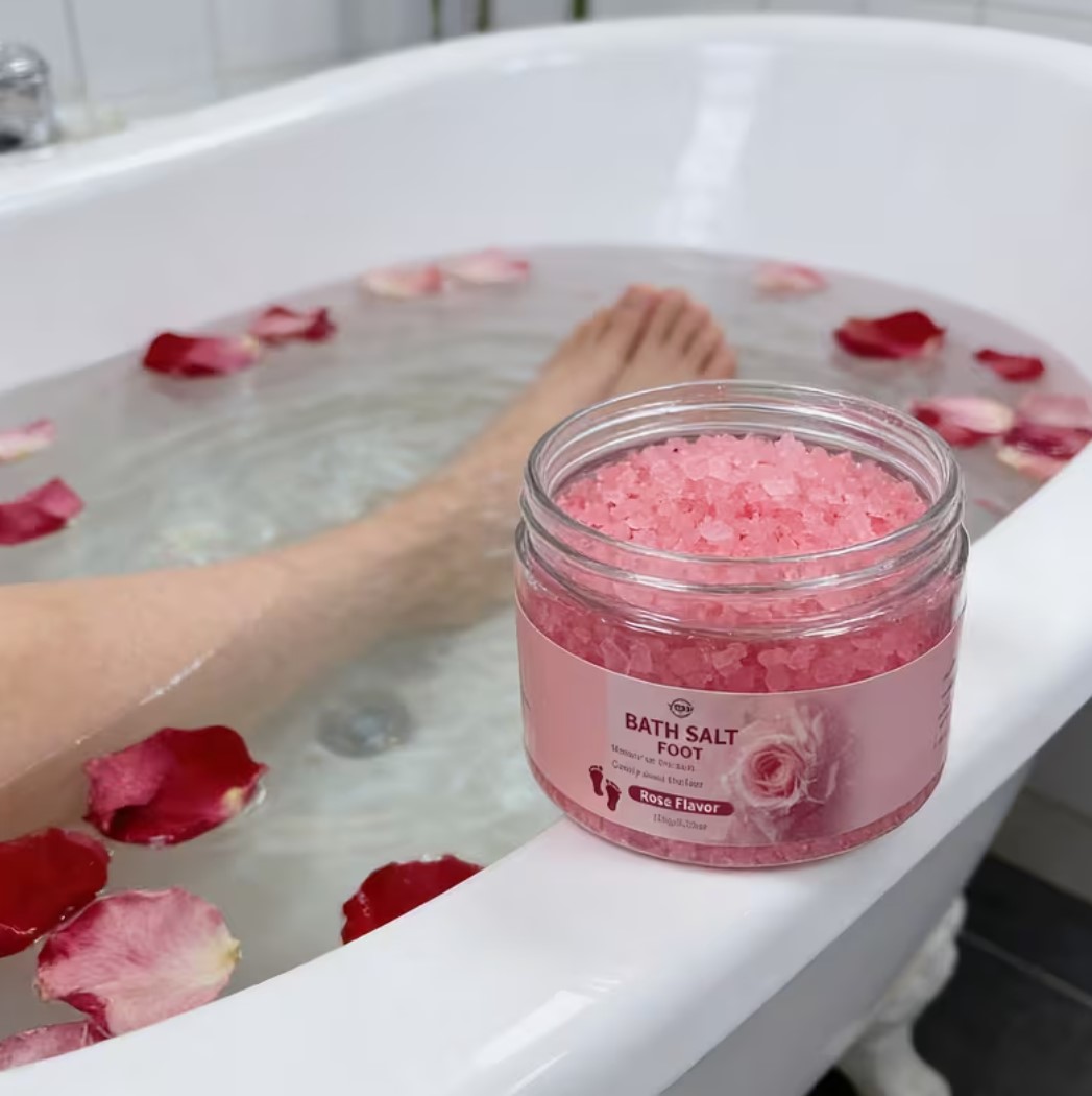 Rose flavour foot bath salt in a glass jar beside a bathtub